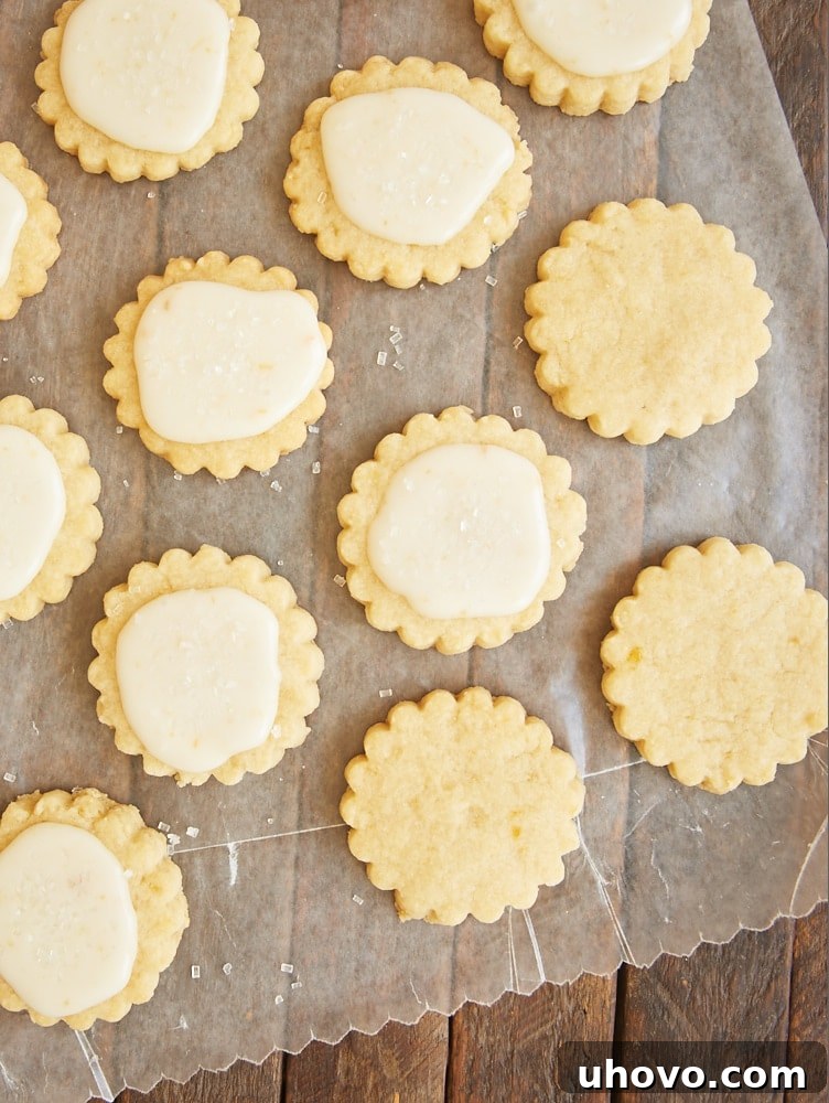 Delicate peach shortbread cookies cooling on parchment paper after baking.