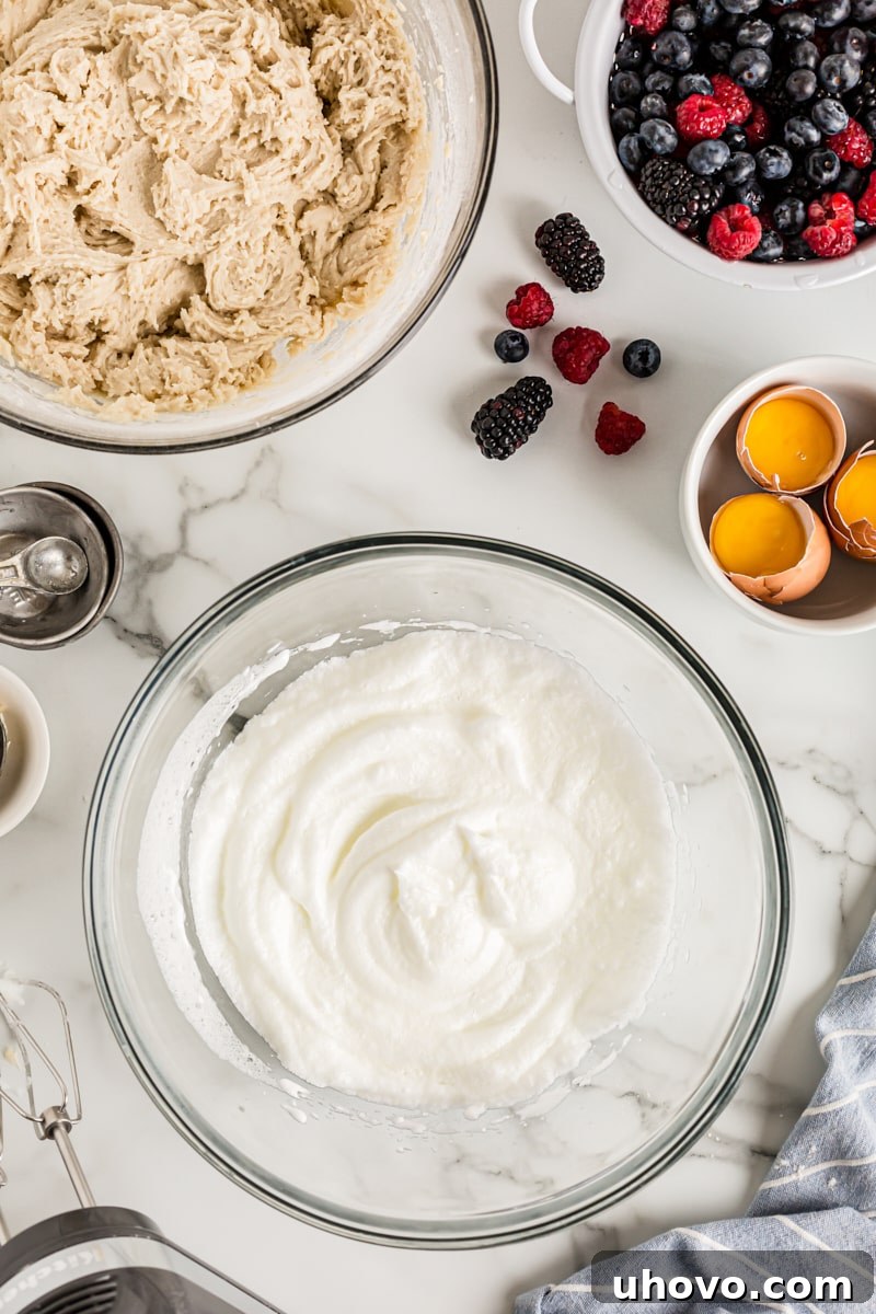 Overhead view of egg whites in glass mixing bowl