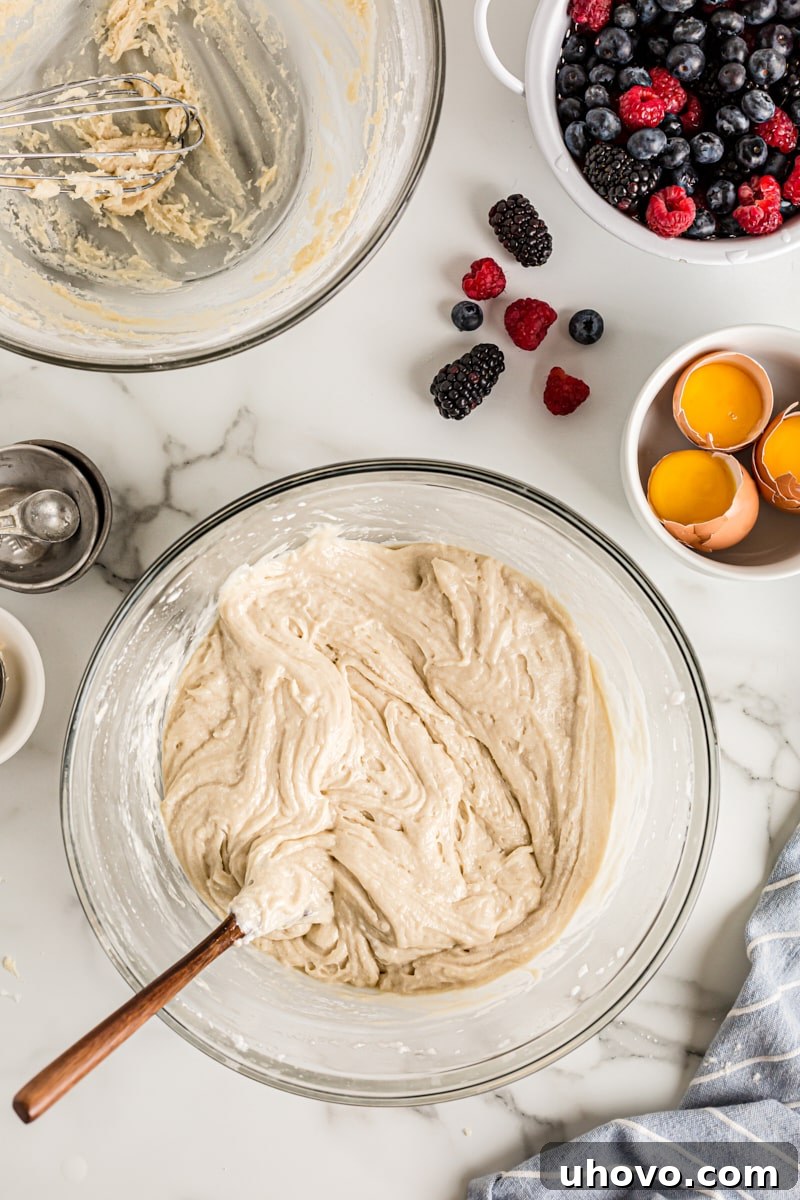 Overhead view of cake batter in glass mixing bowl