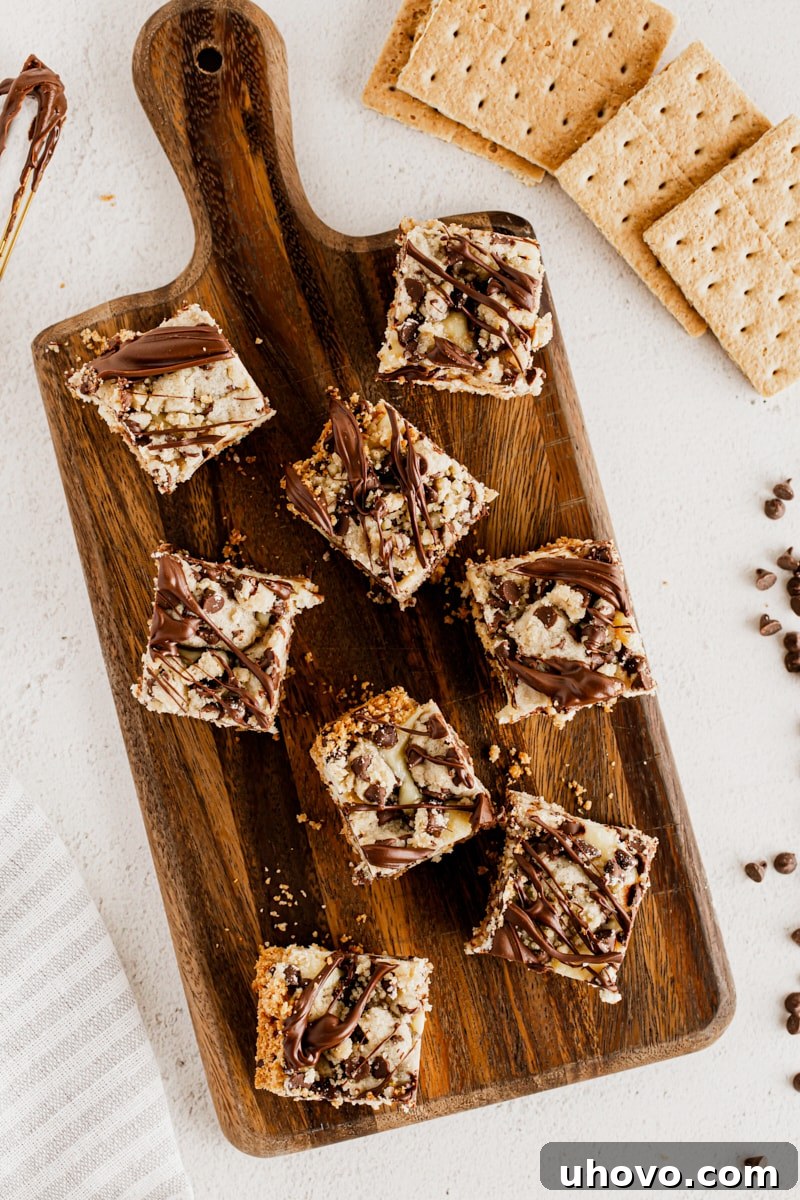 Overhead view of cookie dough cheesecake bars on cutting board