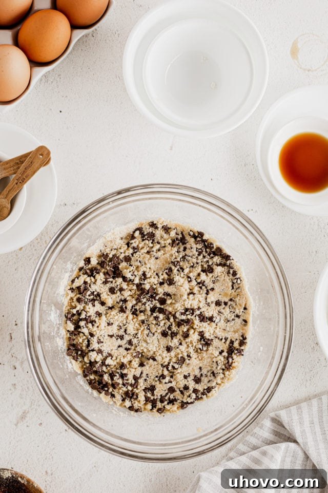 Overhead view of cookie dough mixture in glass mixing bowl