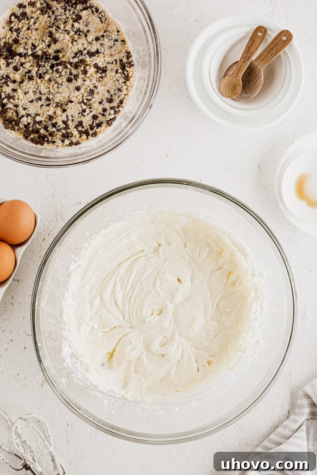 Overhead view of cheesecake filling in glass mixing bowl