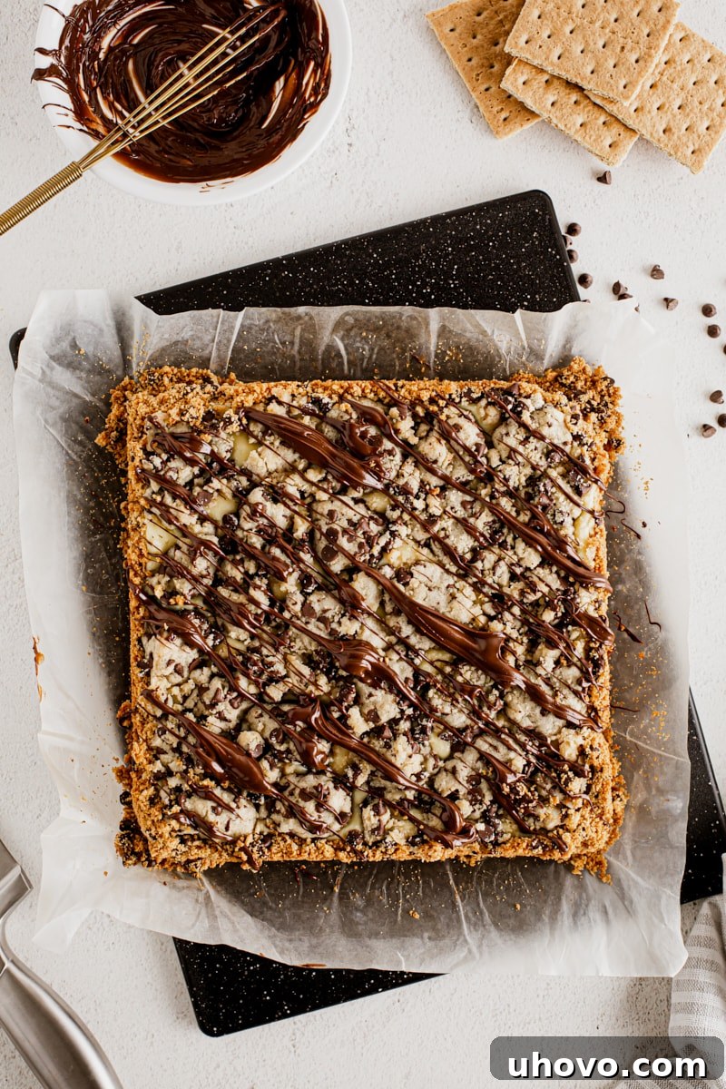 Overhead view of chocolate chip cookie dough cheesecake bars before cutting