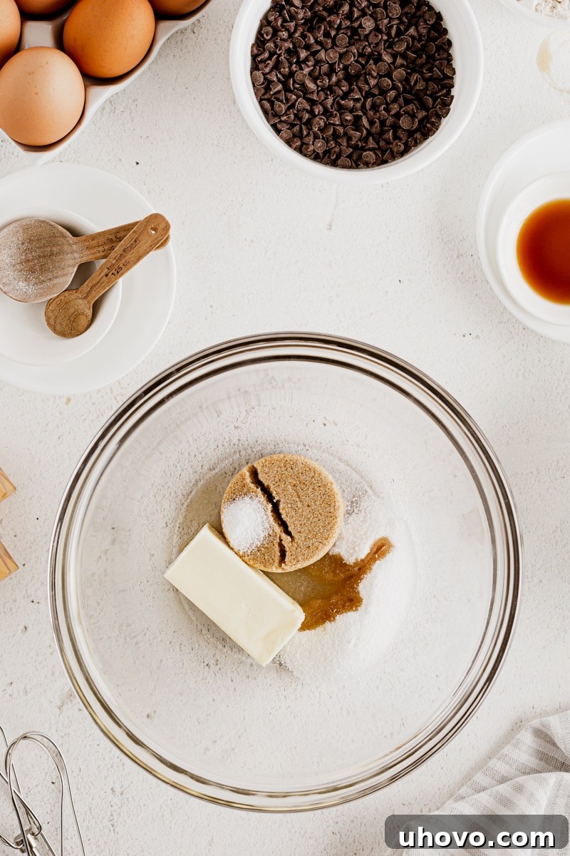 Overhead view of cookie dough ingredients in glass bowl before mixing