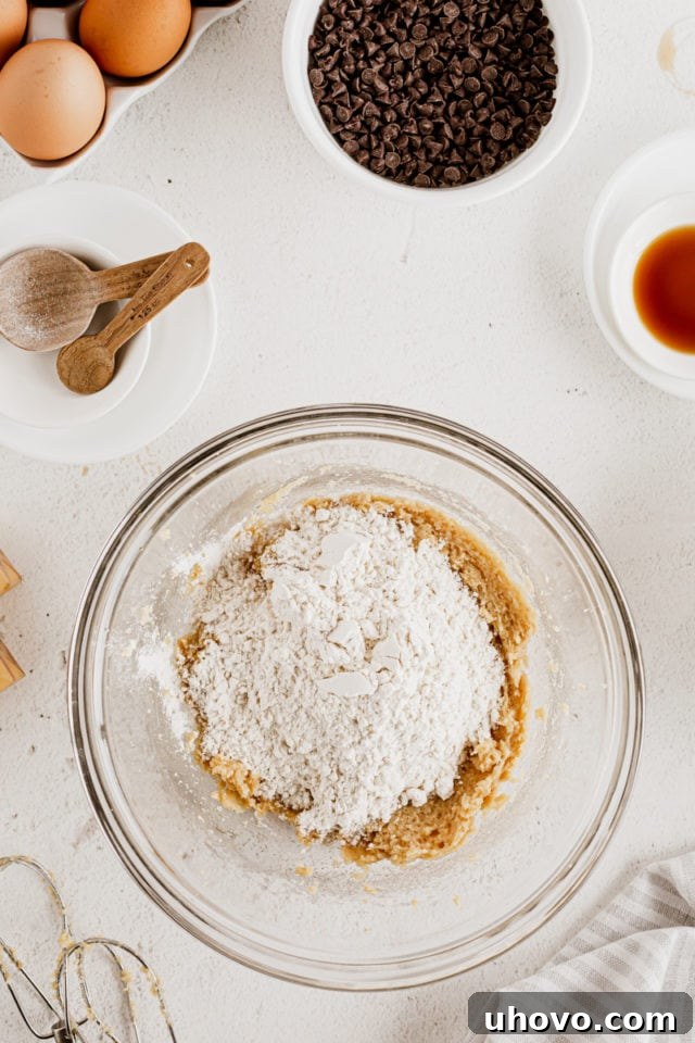 Overhead view of cookie dough ingredients in glass bowl