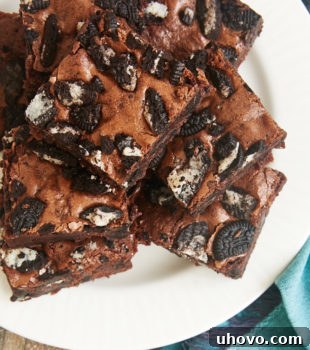 Overhead view of Fudgy Cookies and Cream Brownies, perfectly cut and ready to serve on a white plate.