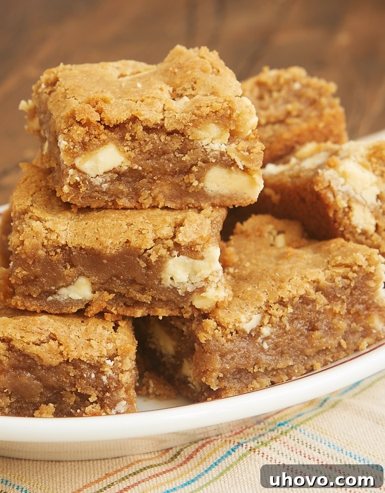 Close-up of a stack of Peanut Butter White Chocolate Blondies with a crackly top