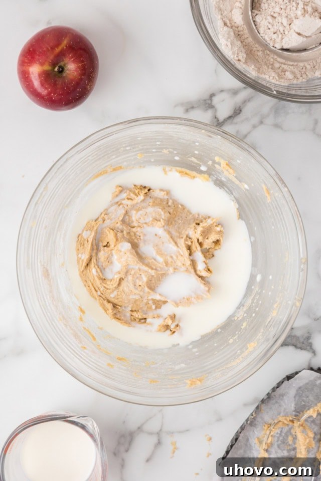 overhead view of milk added to crumb cake batter