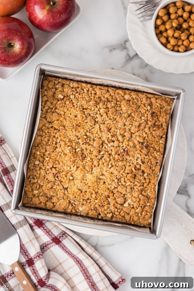 overhead view of freshly baked caramel apple crumb cake in a square baking pan