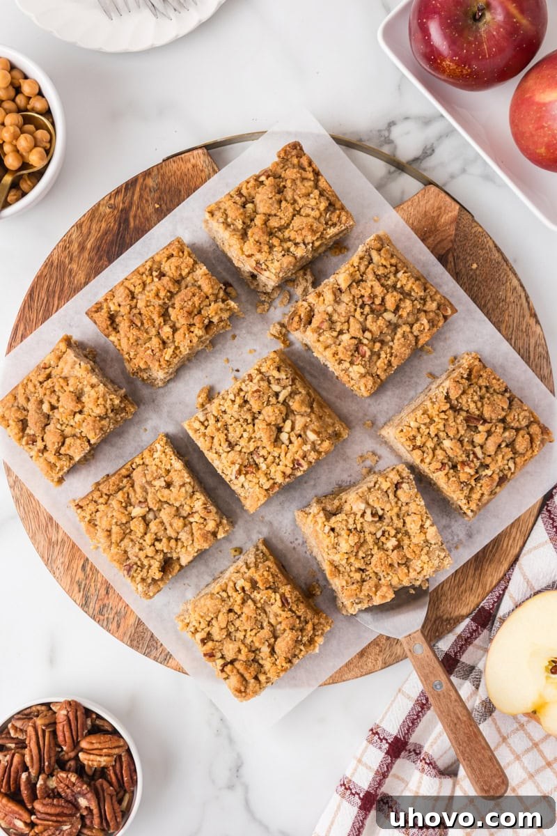 Overhead view of sliced caramel apple crumb cake topped with golden caramel-studded crumbs