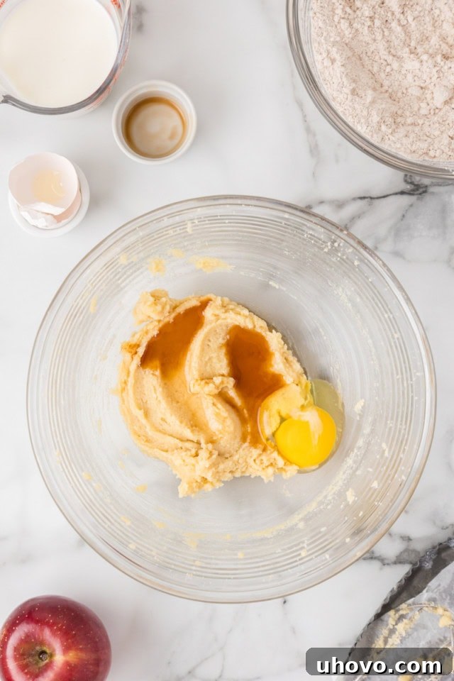 overhead view of egg and vanilla added to creamed butter and sugar