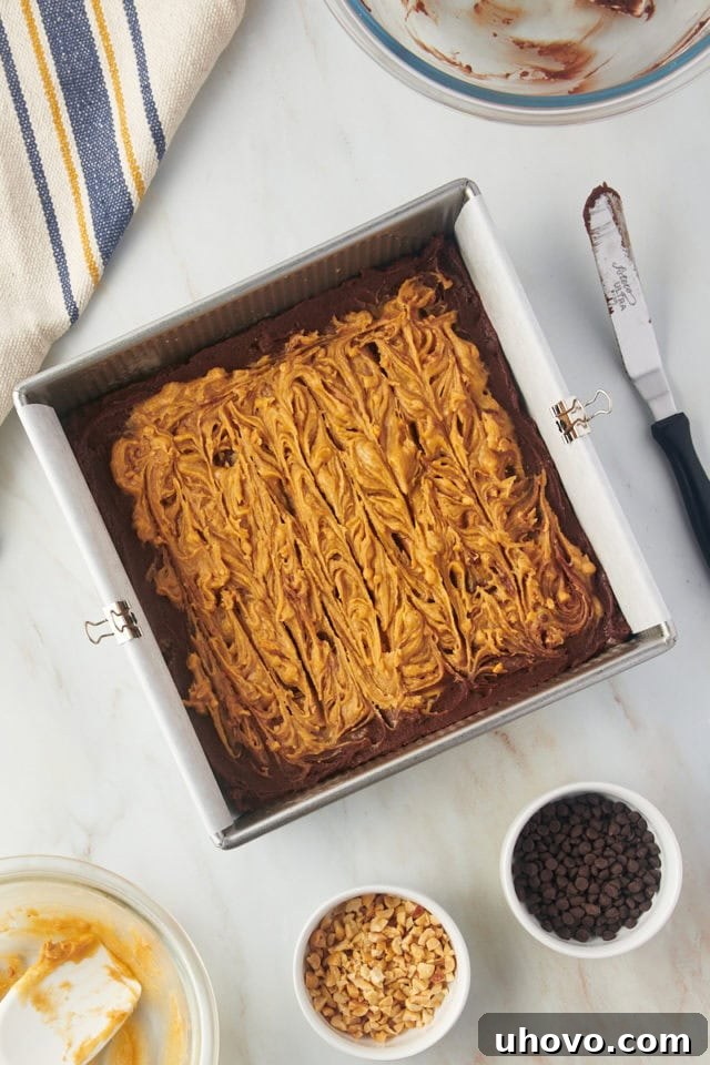 Overhead view of peanut butter swirled into brownie batter