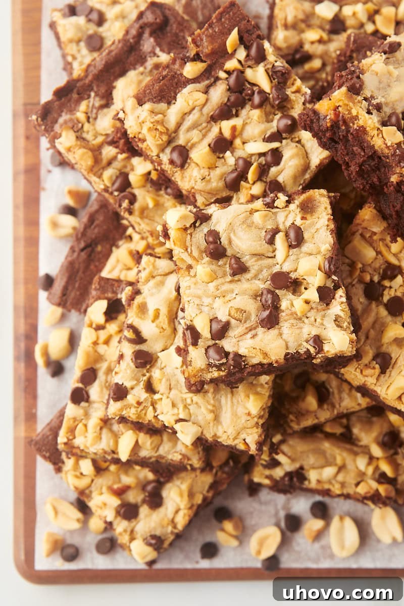 Overhead view of peanut butter swirl brownies stacked on board