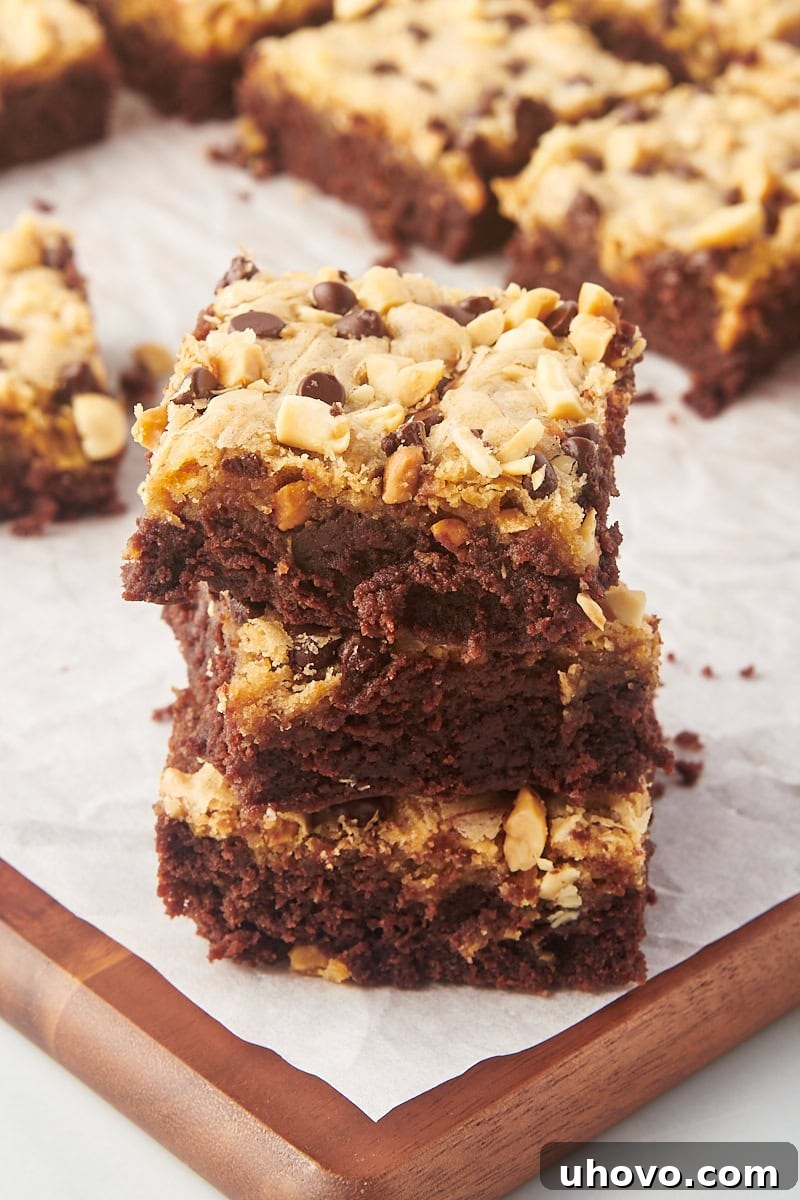 Stack of 3 peanut butter swirl brownies with additional brownies in background