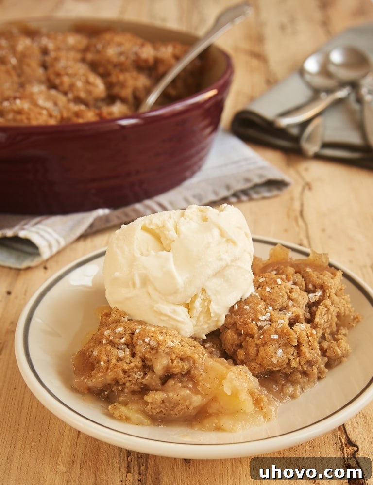 Autumn Spice Pear Cobbler served on a white plate and topped with ice cream