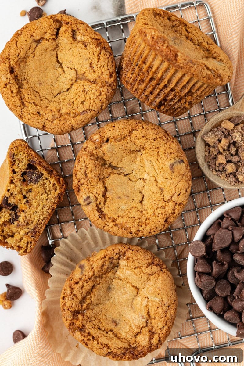 An inviting overhead view of a dozen perfectly baked blondie cupcakes arranged neatly on a wire cooling rack, allowing them to cool completely and achieve their ideal chewy texture.