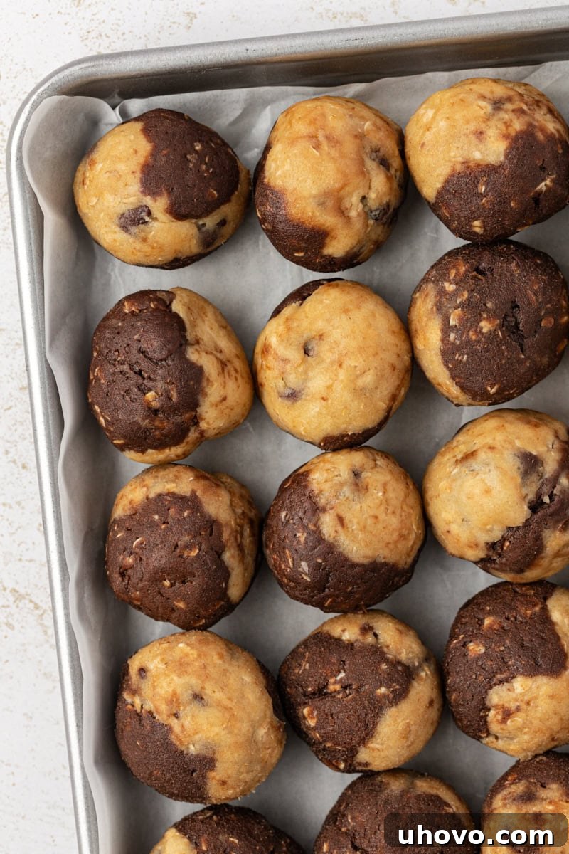 overhead view of marbled chocolate chip cookie dough on a baking sheet