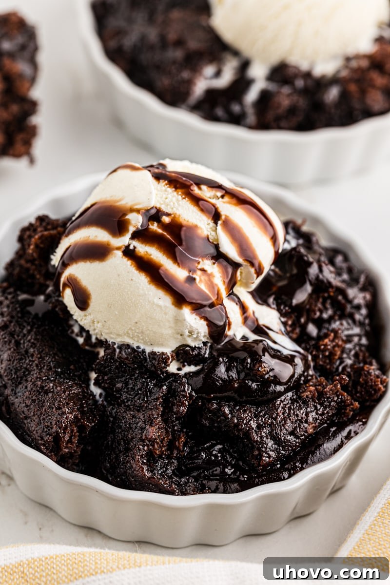 Decadent chocolate cobbler served in ramekins with a scoop of creamy vanilla ice cream on top.