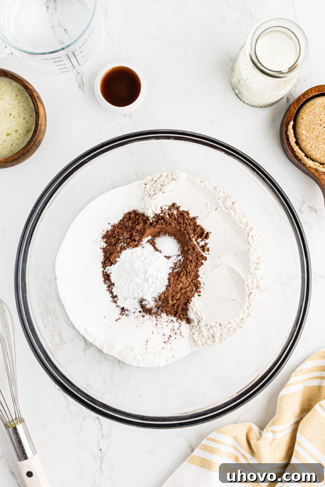Overhead view of dry ingredients for chocolate cobbler in a mixing bowl, prior to combining.