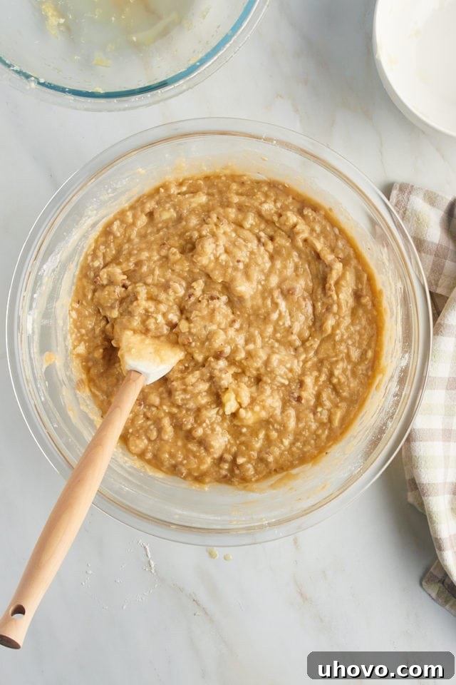 Overhead view of pear bread batter in glass bowl
