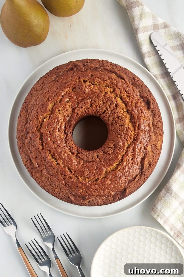 Overhead view of whole pear bread loaf on round white serving platter