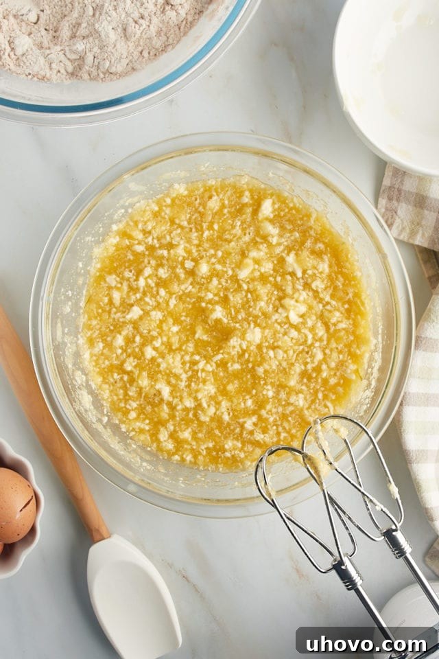 Overhead view of wet ingredients in glass mixing bowl