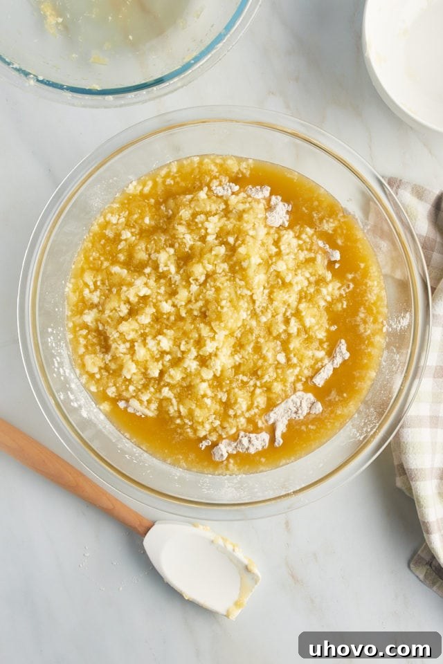 Overhead view of dry ingredients for pear bread added to wet ingredients