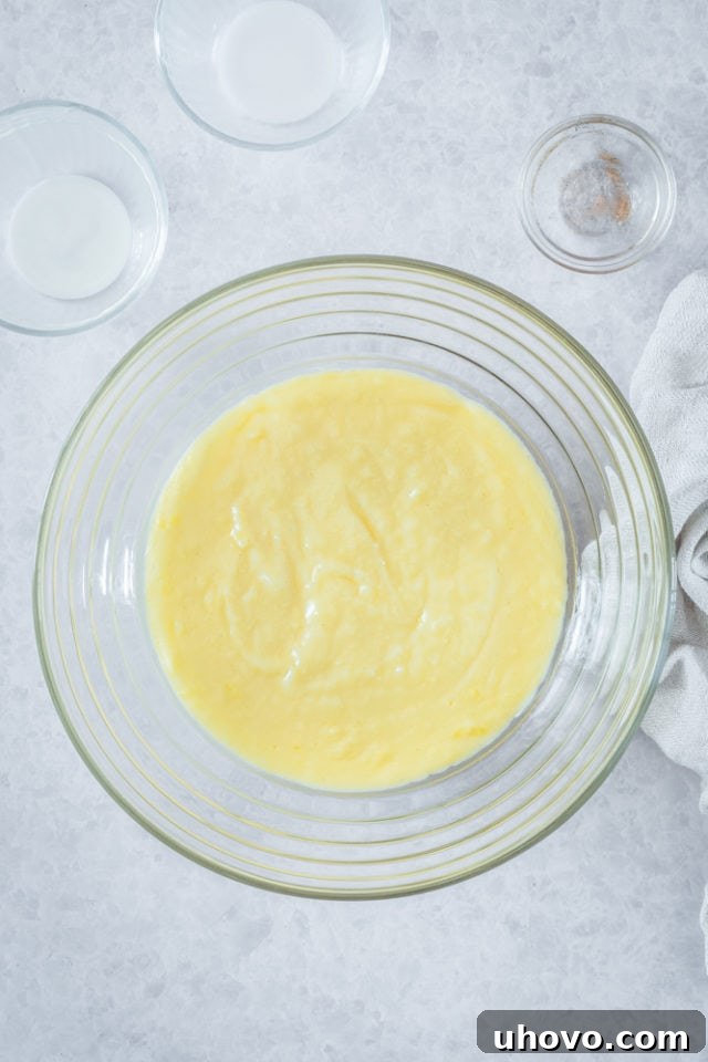 Overhead view of pastry cream in glass mixing bowl