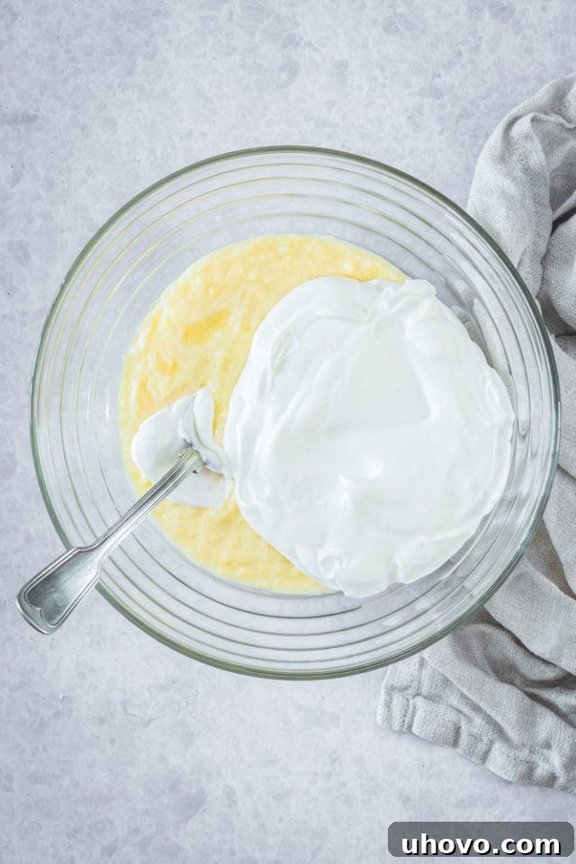 Overhead view of pastry cream and whipped cream in glass bowl