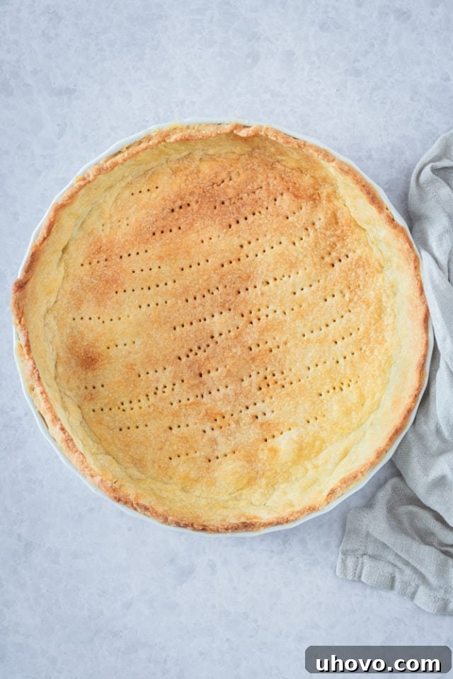 overhead view of baked crust in a pie plate