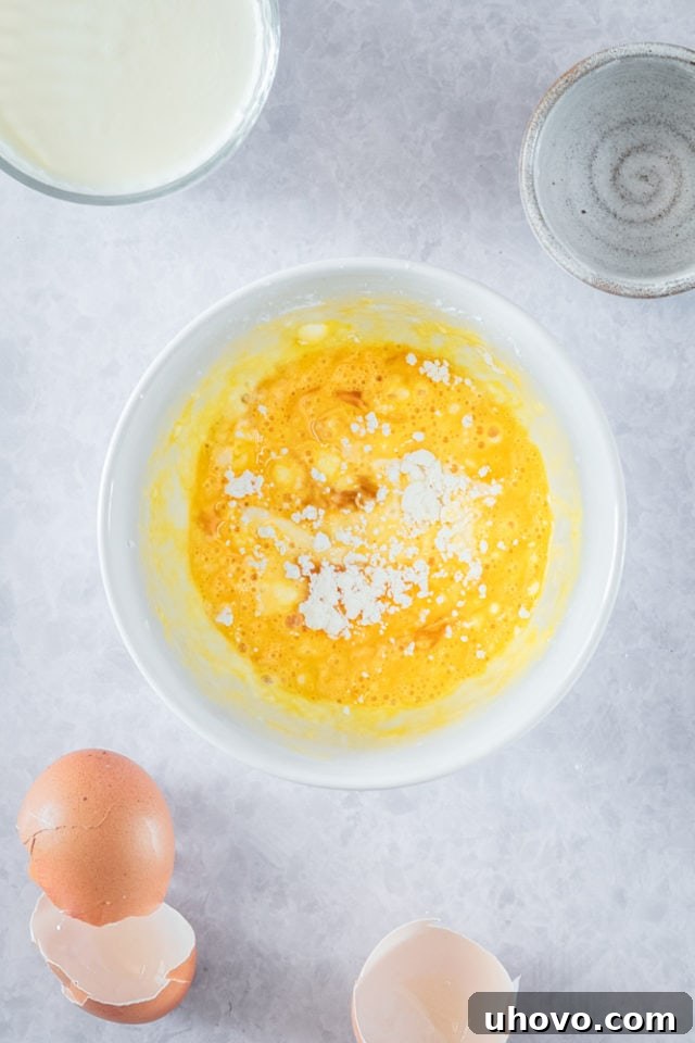 Overhead view of egg mixture in mixing bowl