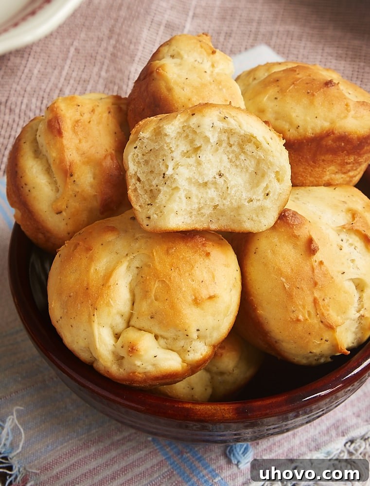 Close-up of fluffy Cracked Pepper Sour Cream Rolls, highlighting the light, airy texture and delicate cracked pepper seasoning.
