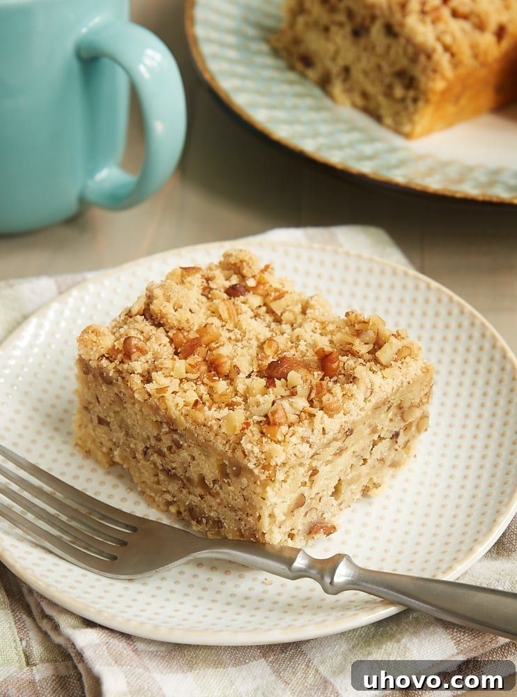 Delicious Brown Sugar Pecan Coffee Cake slice with a warm drink, perfect for breakfast or dessert