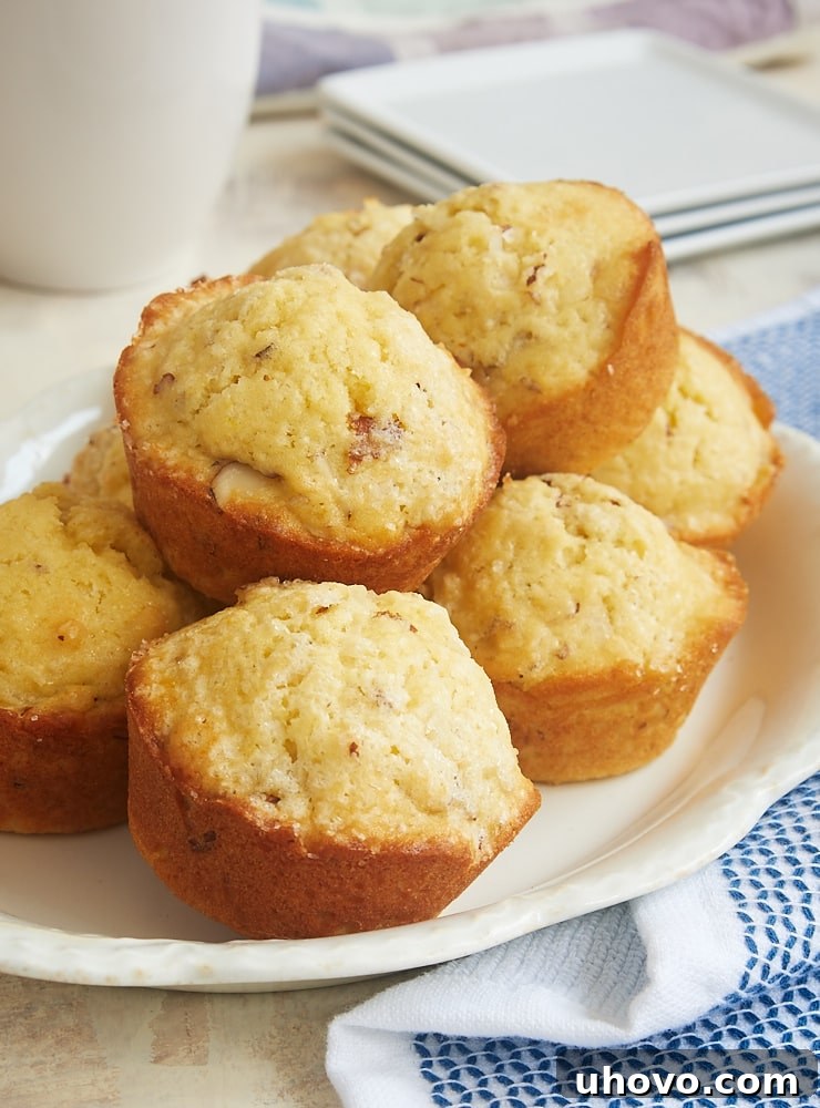 Beautifully baked Coconut Almond Muffins arranged on an oval white serving tray, showcasing their golden-brown tops and inviting texture.