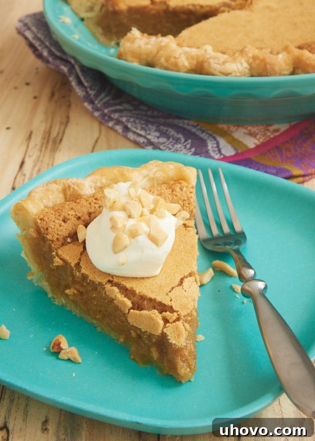 A perfectly sliced Peanut Butter Chess Pie topped generously with sweetened whipped cream, served elegantly on a vibrant green plate, highlighting its creamy texture.