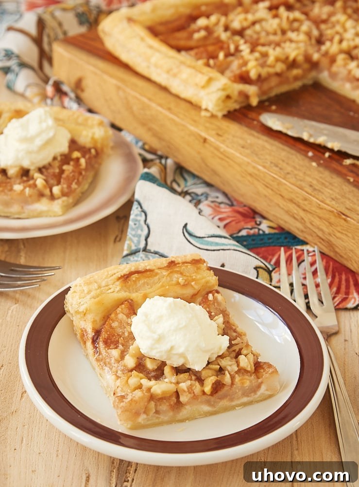 slices of Cream Cheese-Filled Pear Tart on brown-rimmed white plates