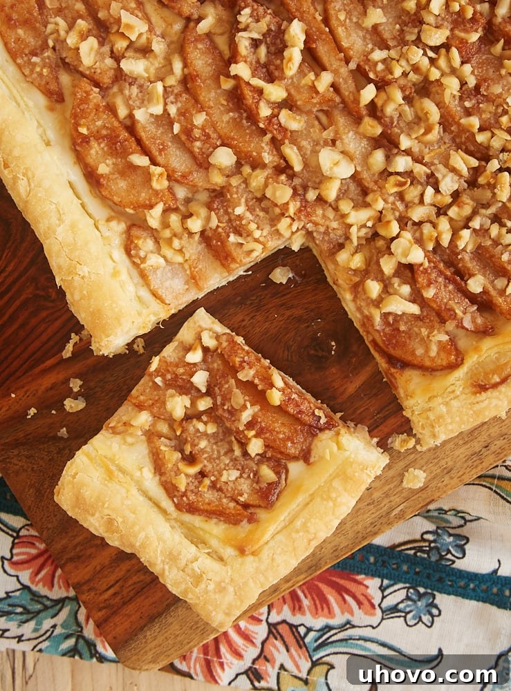 overhead view of Cream Cheese-Filled Pear Tart on a wooden cutting board