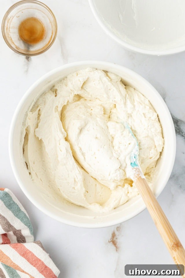 Overhead view of the light and airy no-bake cheesecake mixture in a mixing bowl
