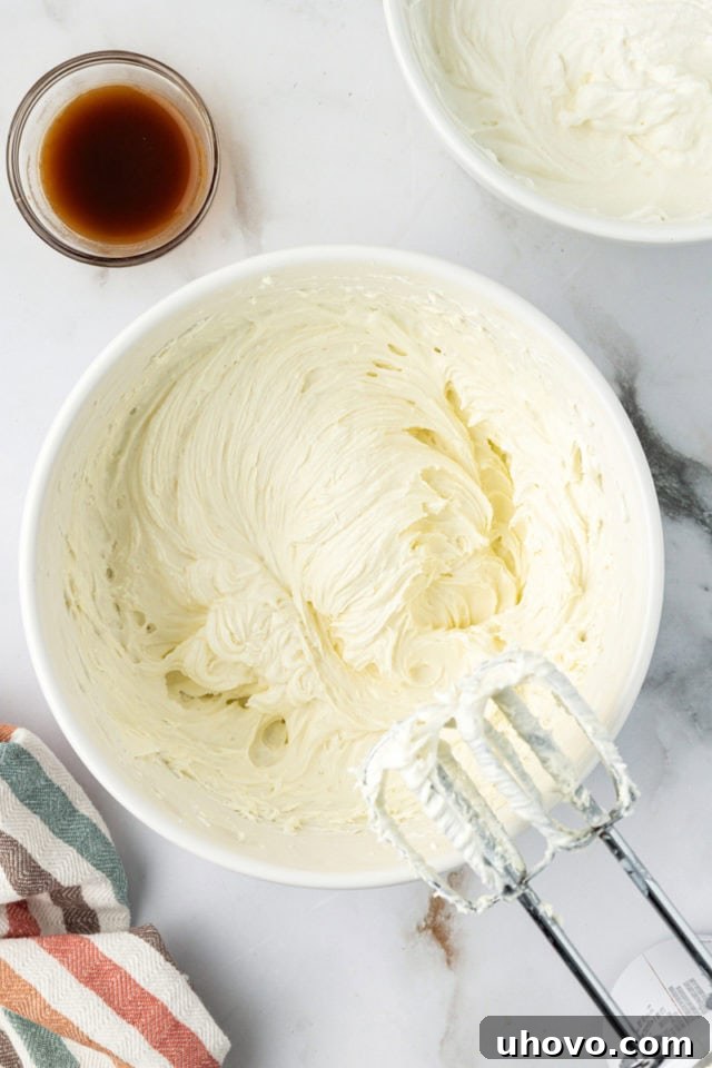 Overhead view of whipped cream cheese mixture in a bowl, creamy and ready