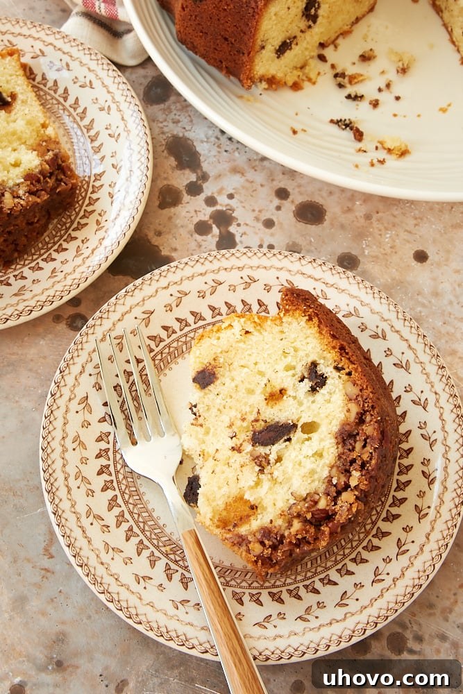 slice of Chocolate Chunk Pecan Crunch Cake on a brown patterned plate