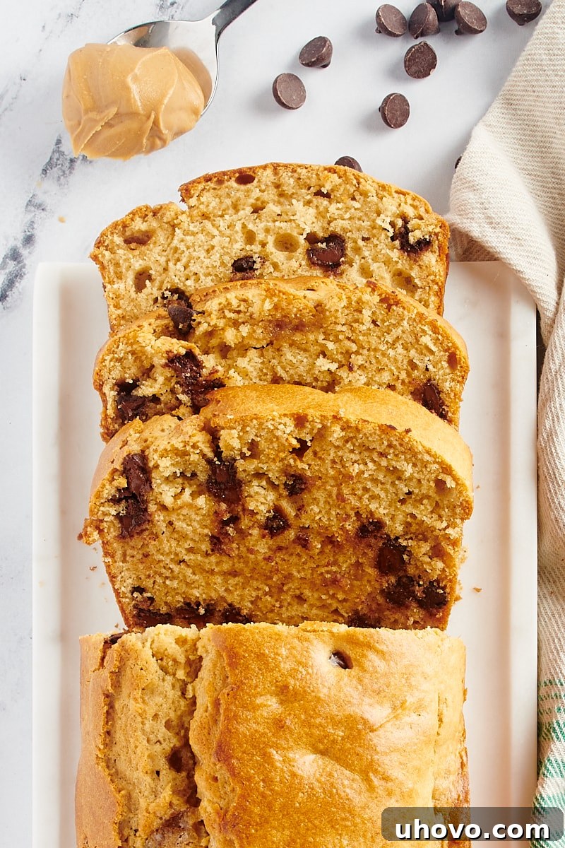 Overhead view of an entire Chocolate Chip Peanut Butter Bread loaf, beautifully sliced and ready to serve.