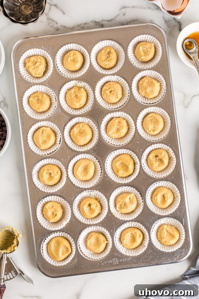 Overhead view of chocolate chip cupcake base in muffin tin