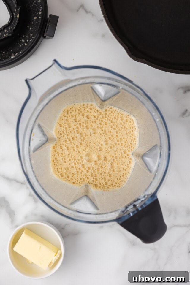 overhead view of smooth Dutch baby pancake mixture in a blender, ready to be poured