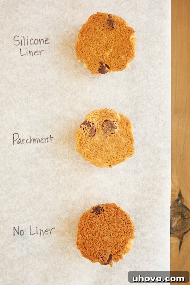 Bottoms of cookies showing different browning levels from unlined, parchment, and silicone lined baking sheets.