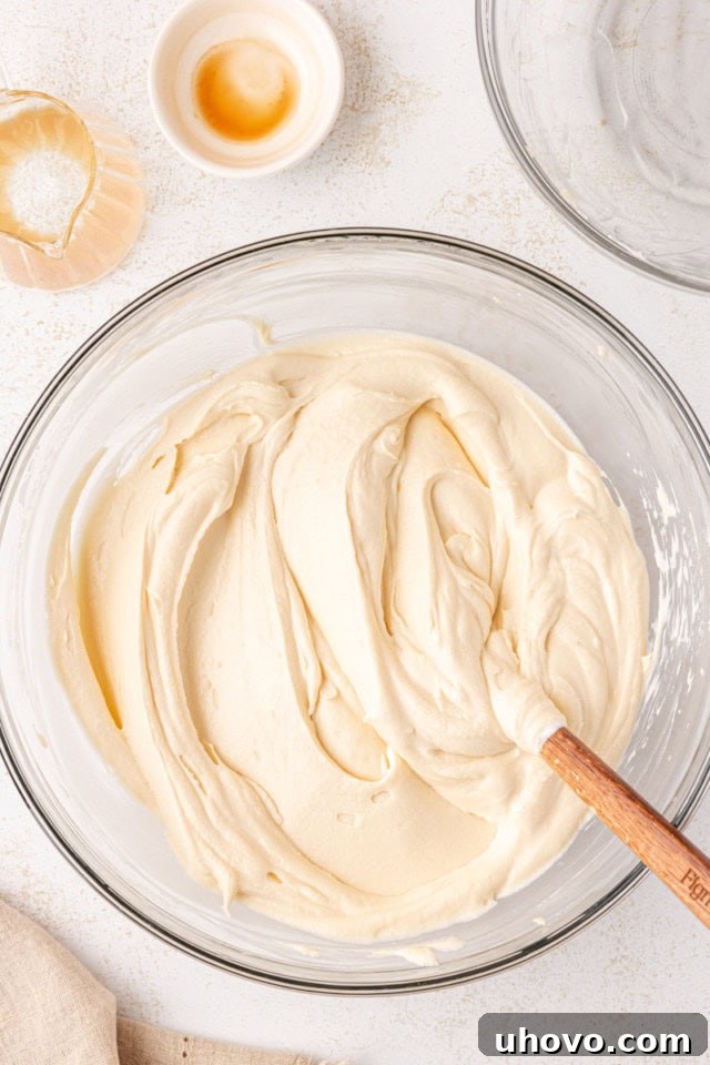The completed no-bake Bailey's cheesecake filling, a perfectly smooth and light mixture, in a glass mixing bowl.