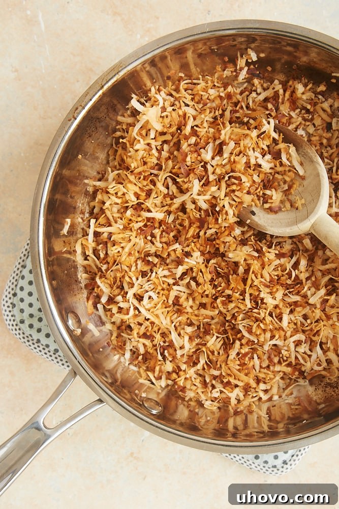 coconut being toasted in a skillet on the stovetop