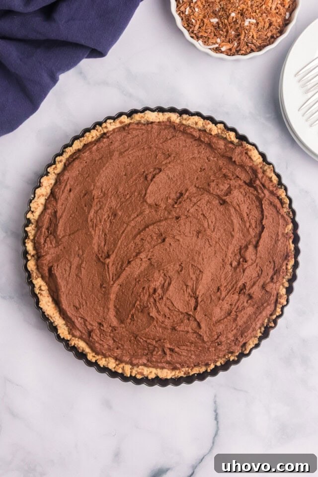 Overhead view of the assembled chocolate mousse pie, ready to be chilled in the refrigerator until set, with a smooth top.