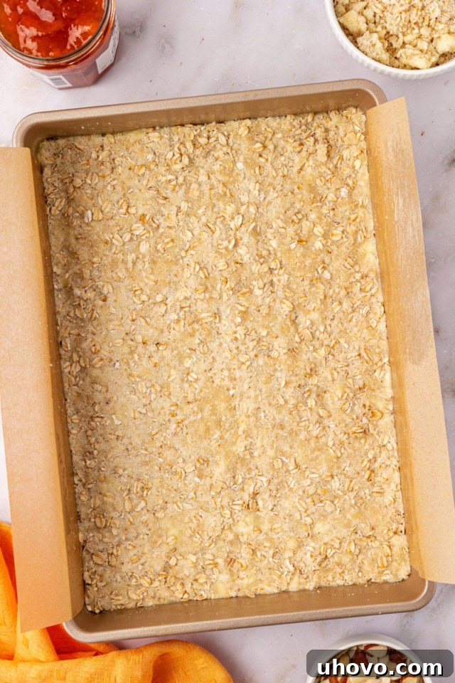 overhead view of crust for apricot bar pressed into the bottom of a rectangular baking pan