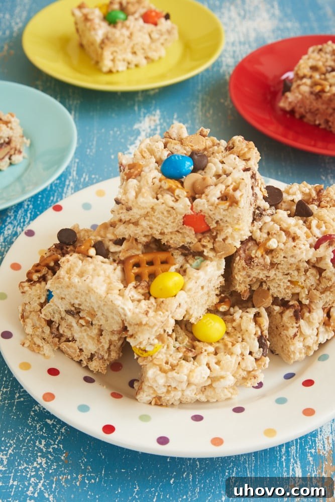 A plate brimming with freshly made Kitchen Sink Crispy Treats, highlighting the diverse mix of ingredients, ready for serving