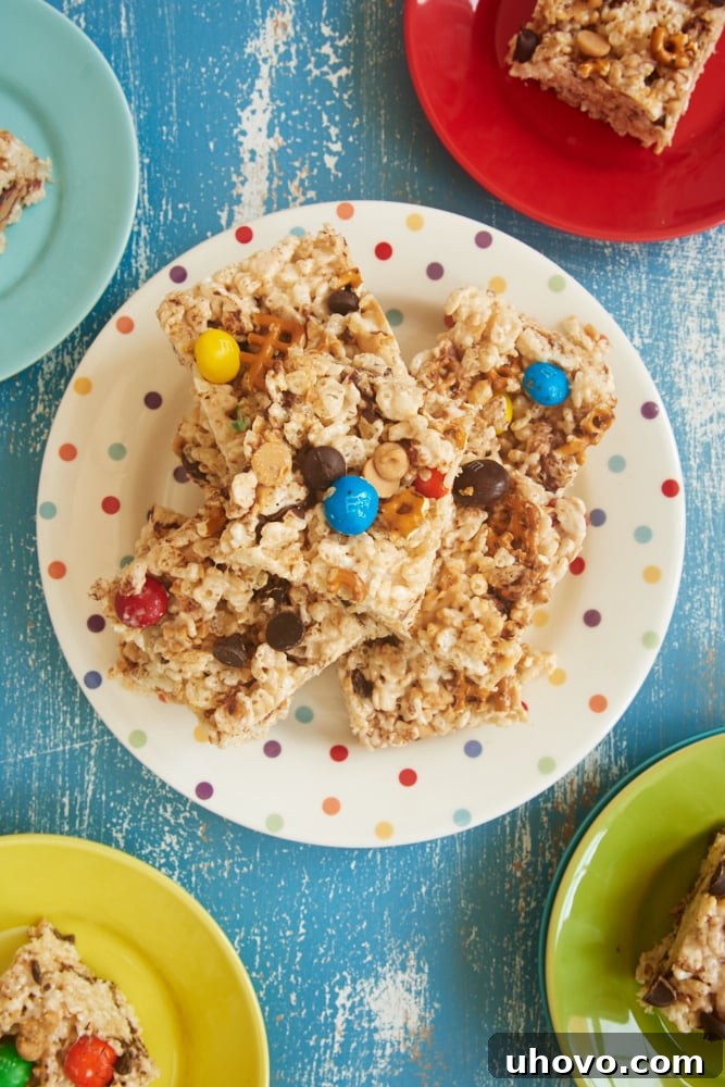 A perfectly set batch of Kitchen Sink Crispy Treats, cut into squares, showing off the various mix-ins